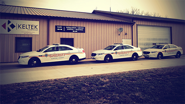 Three sheriff cars parked in front of Keltek