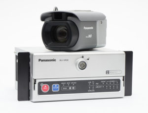 Panasonic Full HD Dash Cam resting on top of Panasonic WJ-VR30 Dash Cam receiver